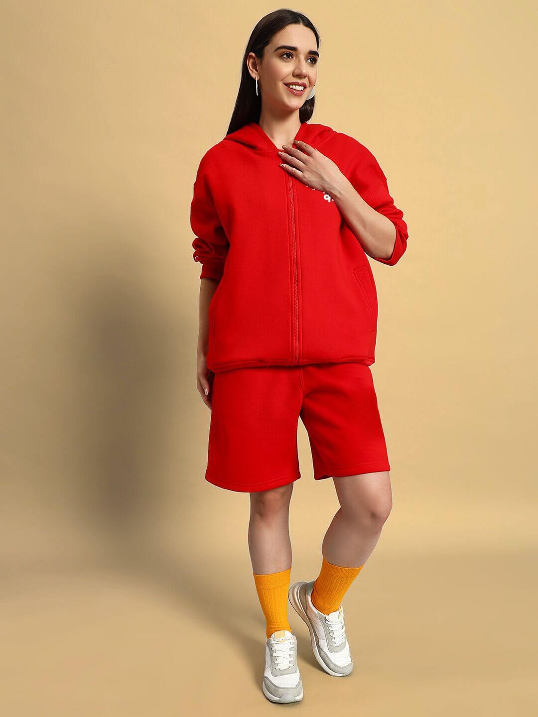 Woman wearing WOMENS A LOOK ATTITUDE FLEECE CO-ORD RED with vibrant red hoodie and shorts, exuding bold fashion and comfort.