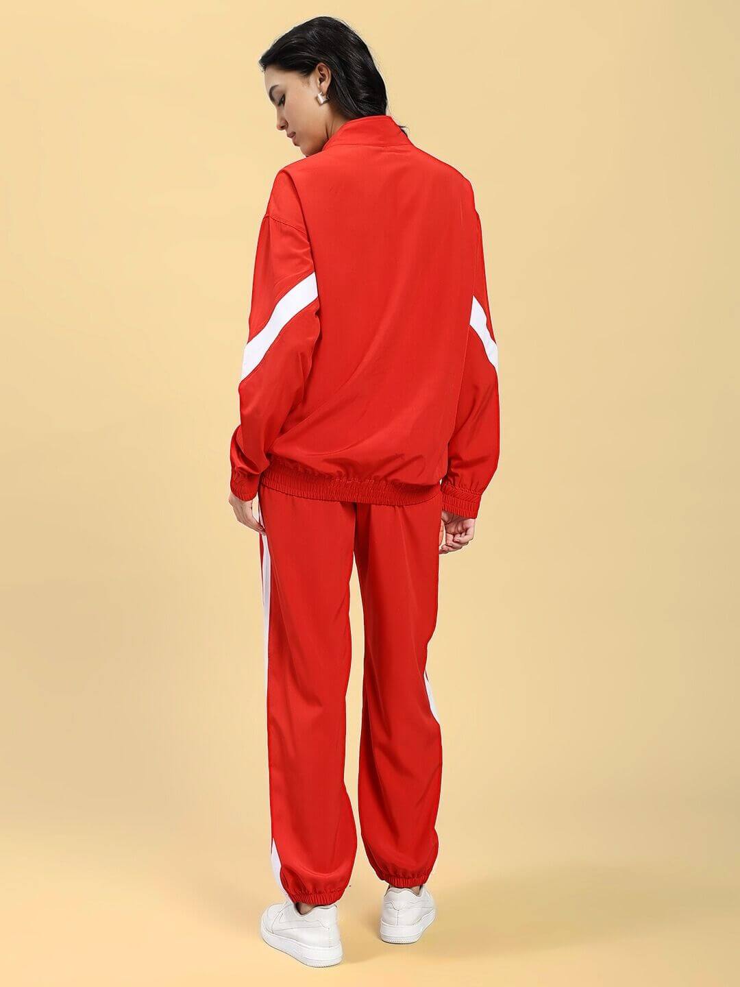 Back view of a woman wearing the WOMEN ROYAL COMFORT RELAXED FIT CO-ORD SET RED with white stripes, showcasing comfort and style.