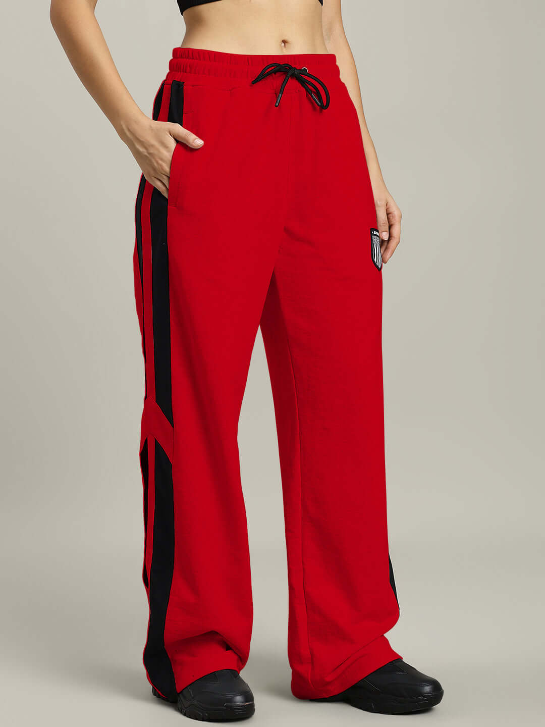 Red WOMEN'S ROYALSON joggers made to order, featuring a drawstring waist and black stripe detail; customizable fit available.