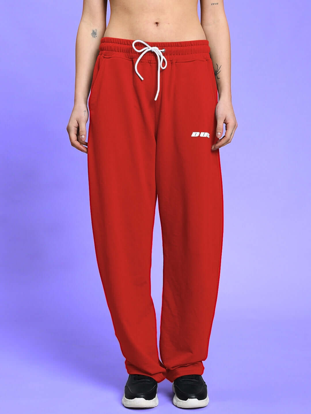 Model wearing red Women's Lia Co-Ord Set joggers with elasticated waistband and drawstring, showcasing relaxed fit and comfort.