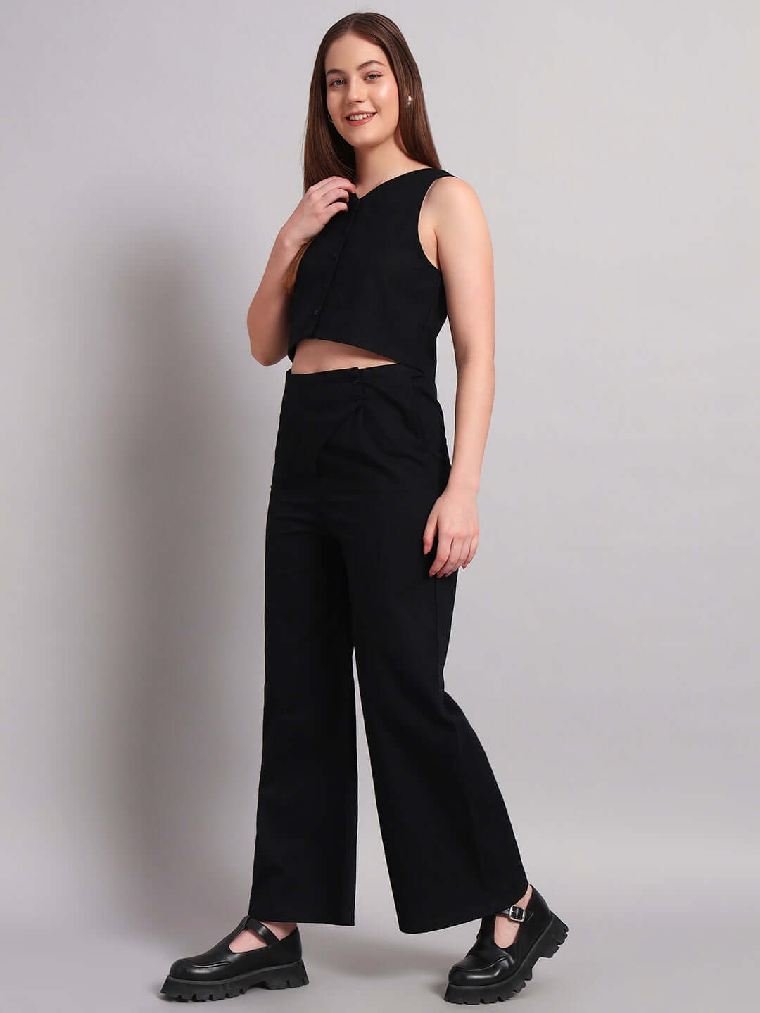 Woman wearing DUDS Women's Chic Relaxed Fit Jogger in black, styled with matching sleeveless top and casual shoes.