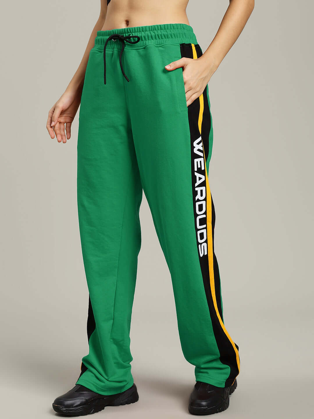 Woman wearing WOMENS ROGER RELAXED-FIT JOGGERS GREEN with elastic waistband and side stripes.