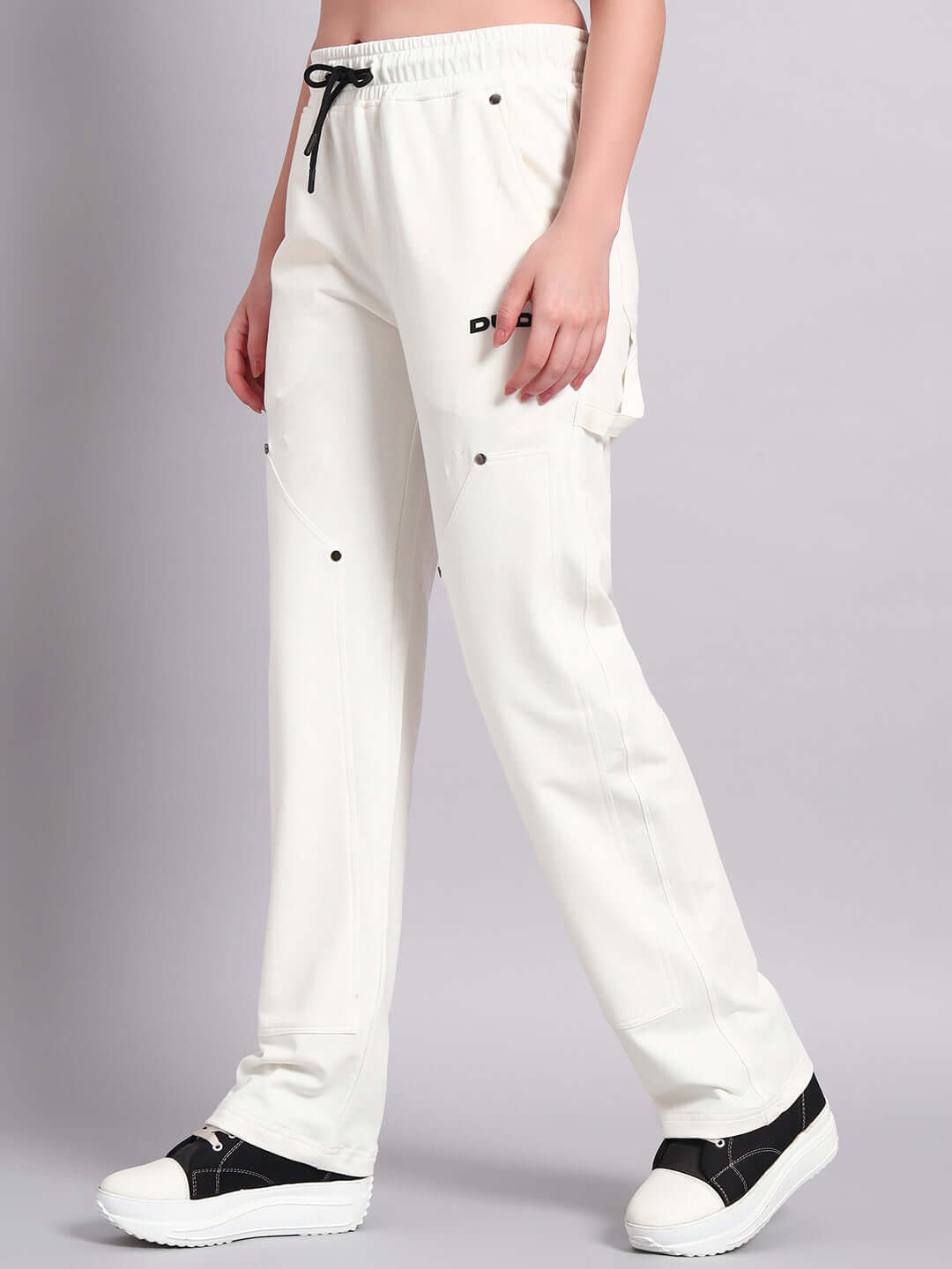 Model wearing Women's Regulus Relaxed-Fit Joggers in white with customizable size options for a perfect fit, by DUDS.