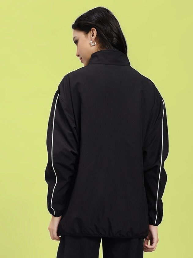 Back view of WOMEN RELIGHT RELAXED FIT JACKET BLACK with reflective trims, showcasing modern design and functionality.