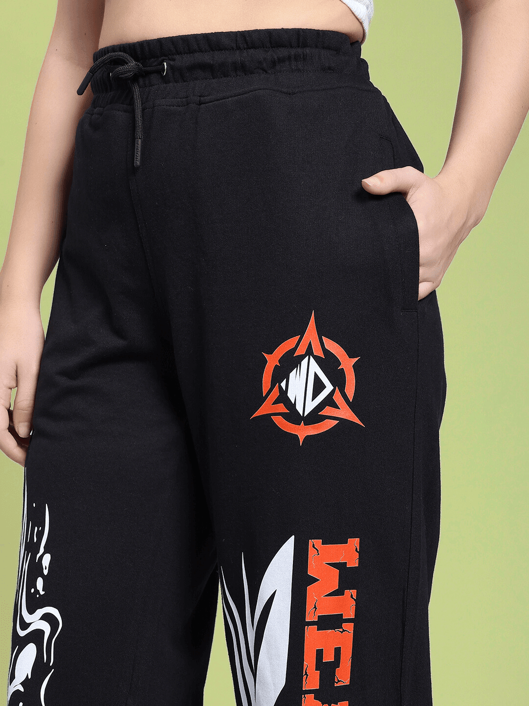 Close-up of WOMEN RIFT RELAXED FIT JOGGER IN BLACK with colorful graphic designs on thigh.