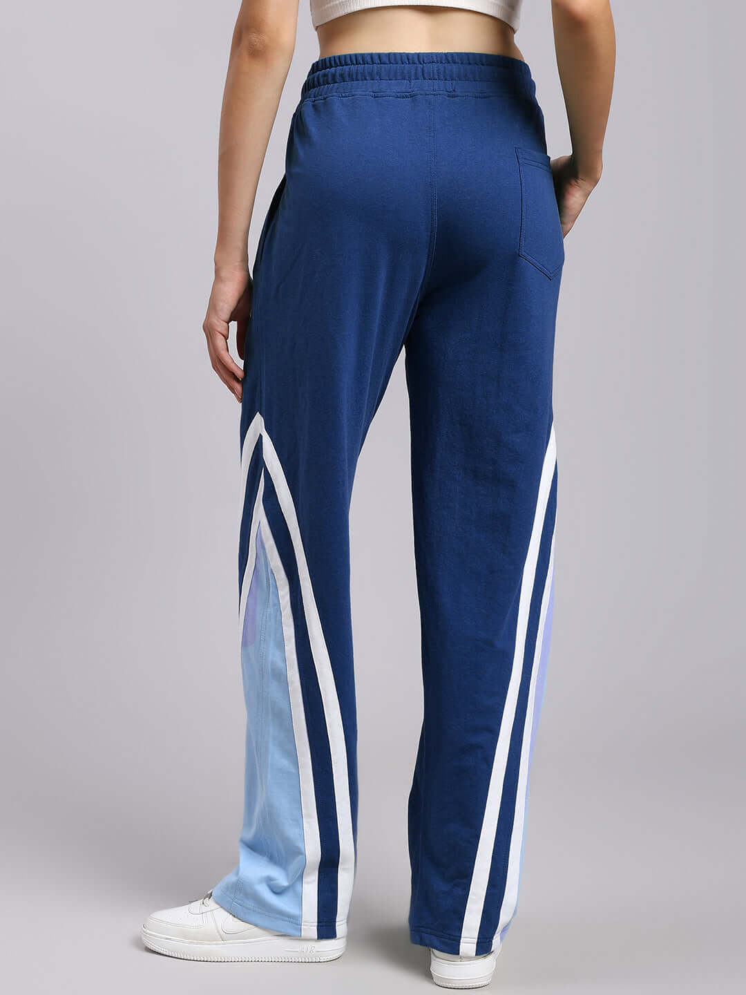 Back view of Women's Rio One Relaxed Fit Joggers in vibrant blue with stylish side stripes, perfect for comfort and style.
