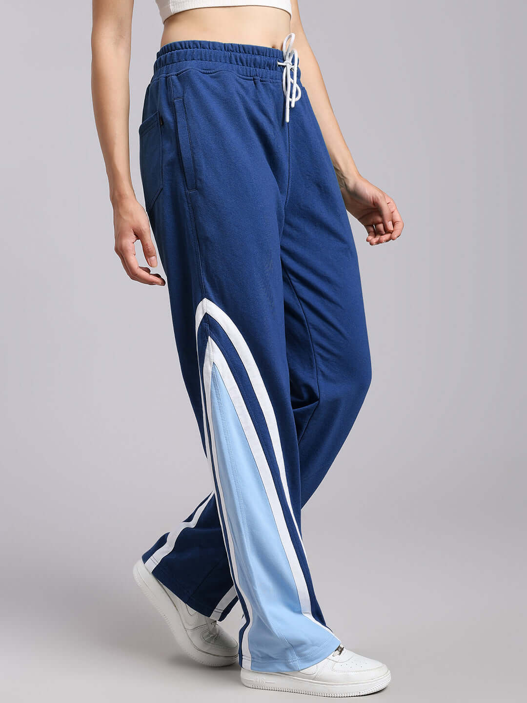 Women's Rio One Relaxed Fit Joggers in Blue with white sneakers, customizable for prepaid orders, tailored by DUDS.