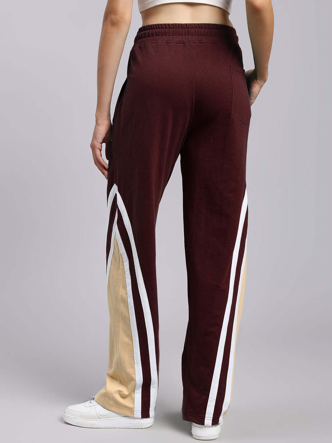 Back view of Women's Rio One Relaxed Fit Joggers in maroon with beige and white stripe detail.