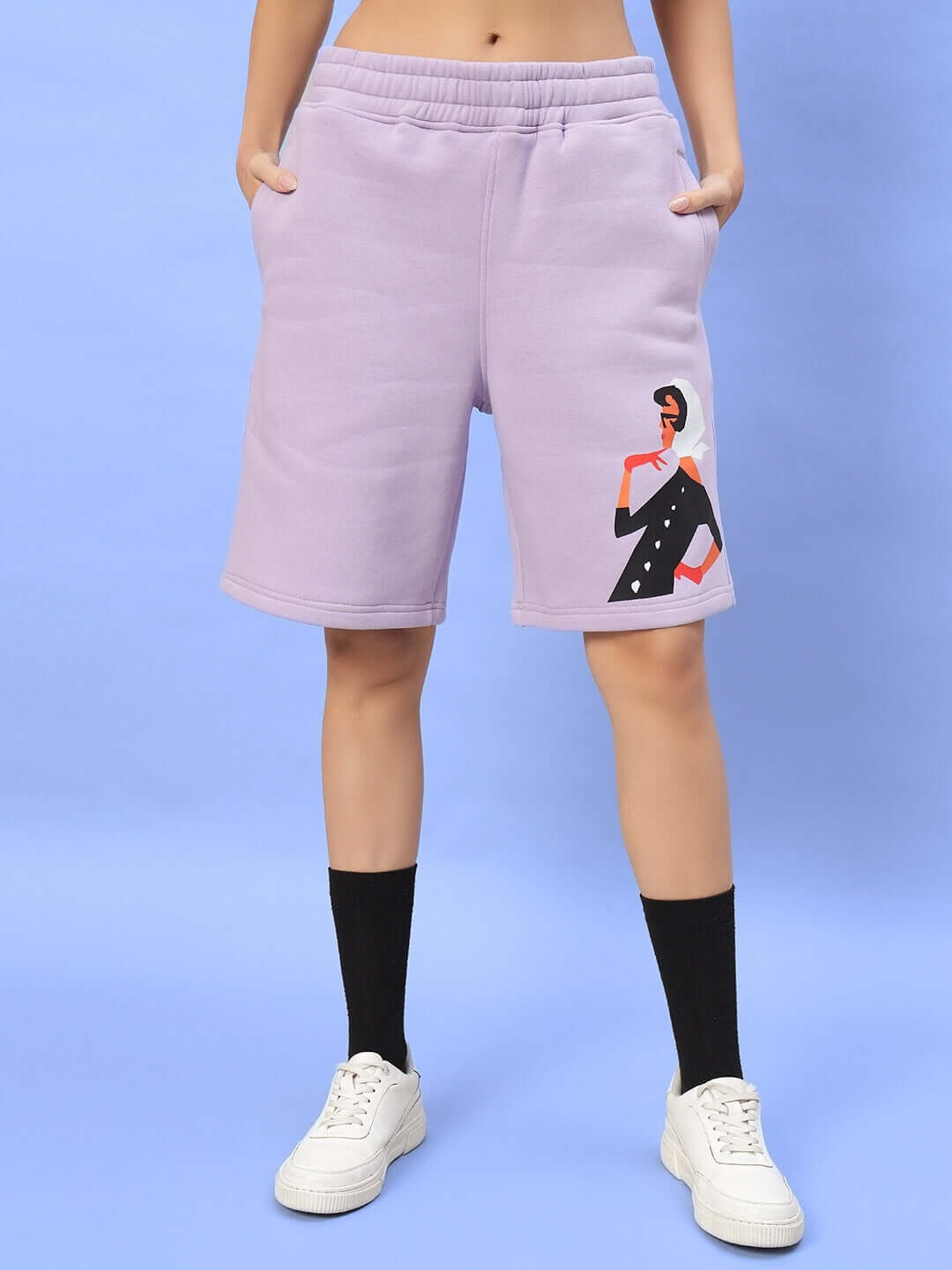 Model wearing WOMEN RITZY FLEECE SHORTS LILAC with fashion print on left side, showcasing comfortable casual wear.