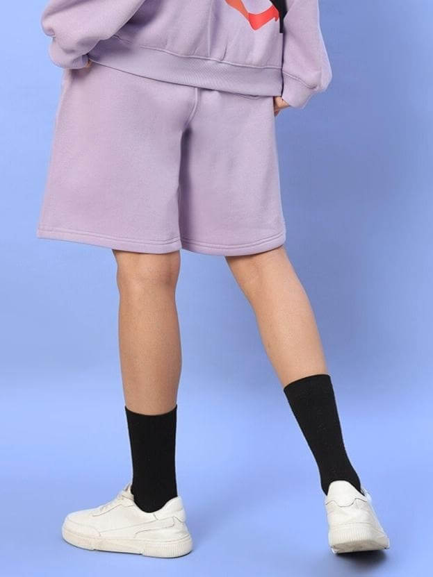 Back view of WOMEN RITZY FLEECE SHORTS LILAC with casual black socks and white sneakers.