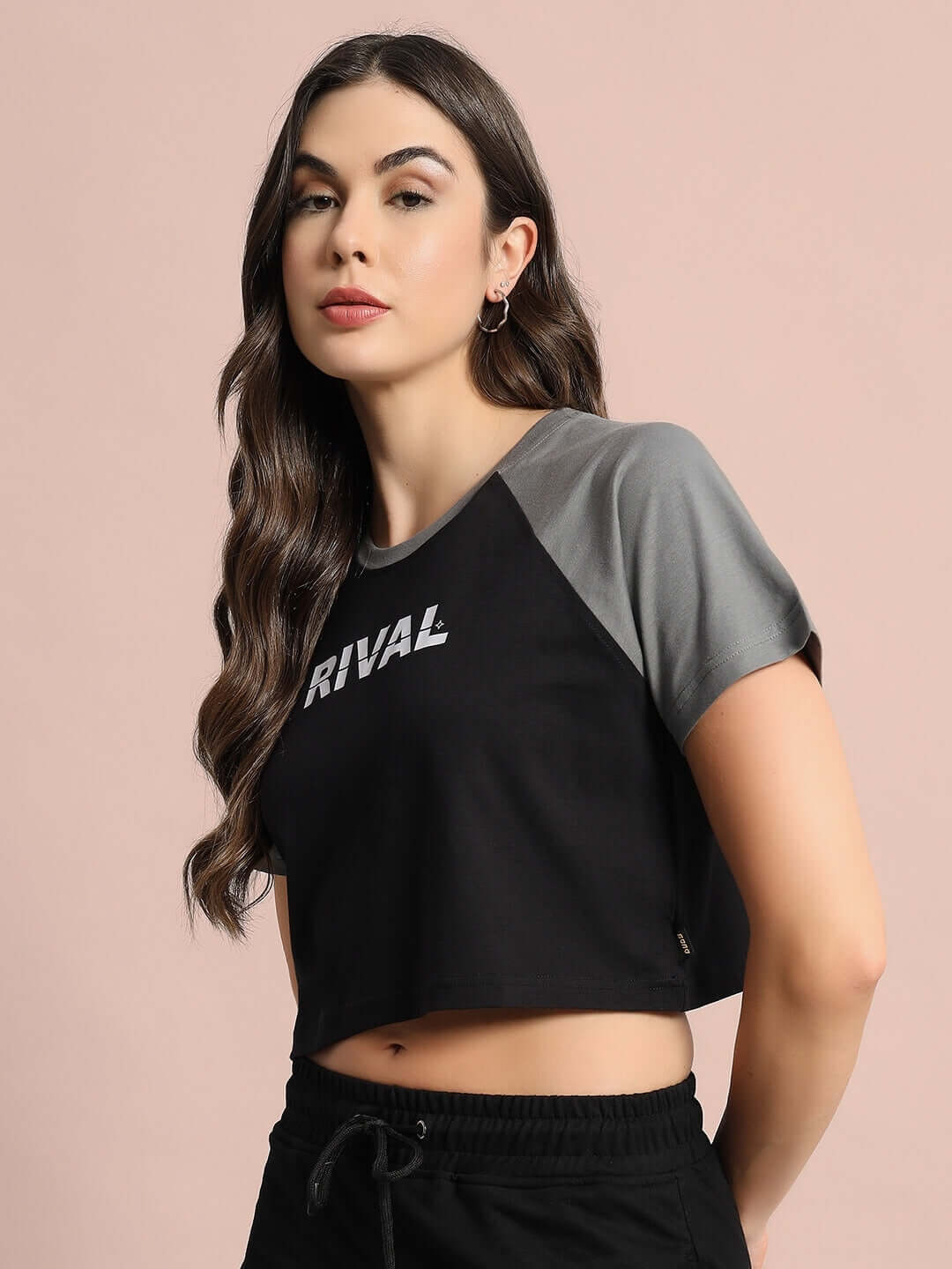 Model wearing Women's Rival Raglan Crop-Top in Black Grey, made of 100% cotton with premium heavy gauge fabric.
