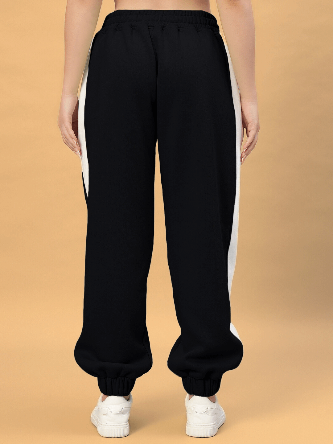 Back view of Women's Rizzler Colorblock Co-ord Pants in black, featuring white side panels, displayed on a neutral background.