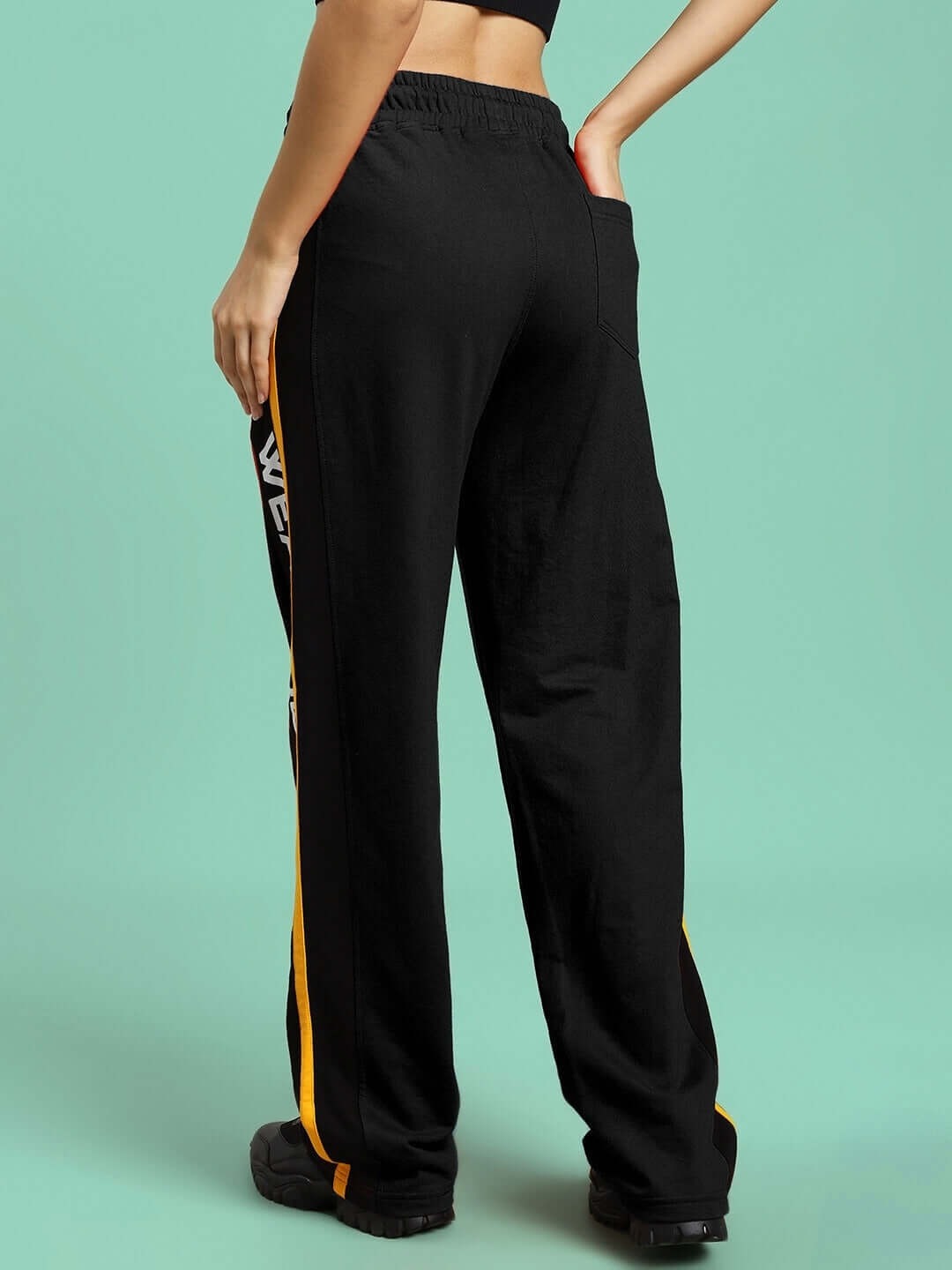 Back view of WOMENS ROGER RELAXED-FIT JOGGERS BLACK showing relaxed fit and vibrant side stripe.