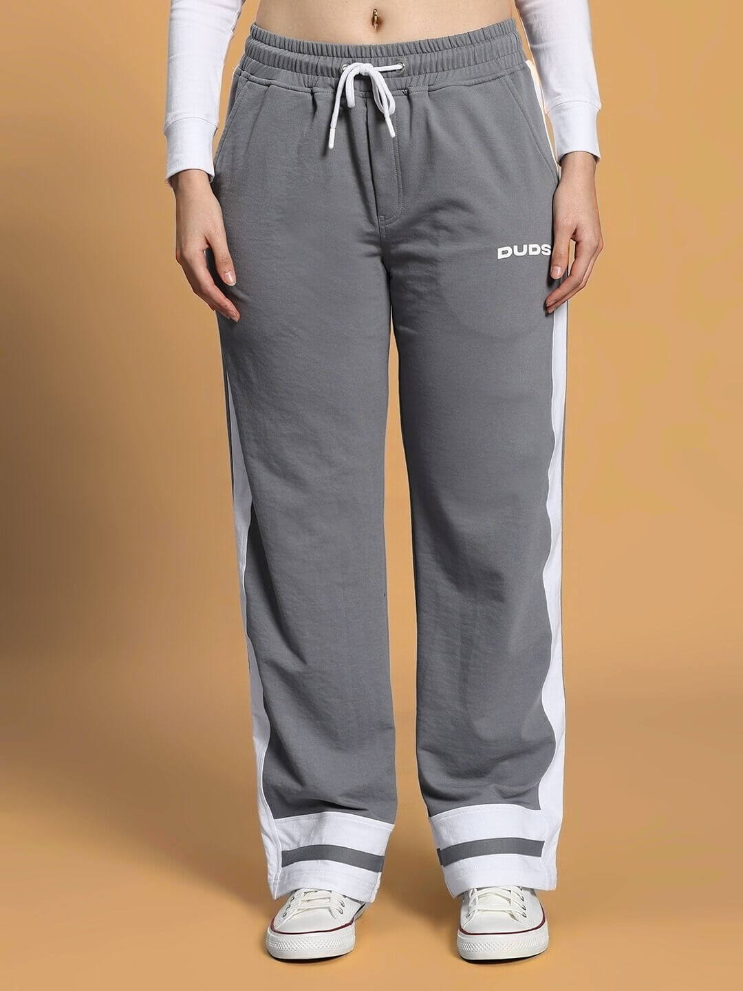 Women's grey jogger pants with white side stripes and DUDS logo.