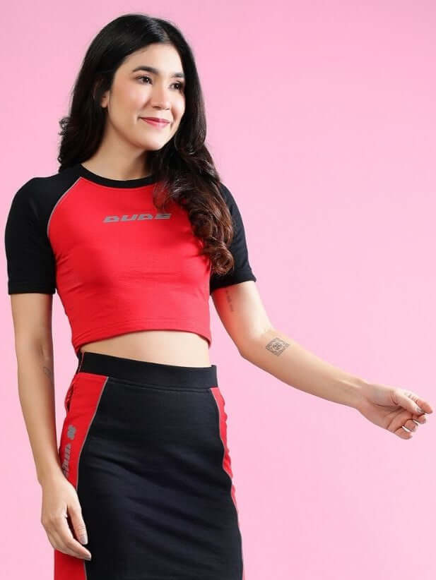 Woman wearing Women's Rosalina Colorblock Crop-Top in red and black, made from premium heavy gauge 100% cotton fabric. Stylish and modern design.