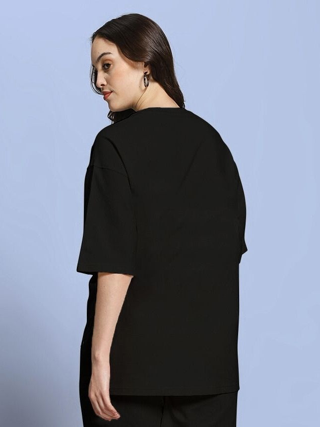 Back view of WOMEN ROSE CHARM OVER-SIZED T-SHIRT BLACK on model, showcasing an oversized fit with a comfortable and stylish design.