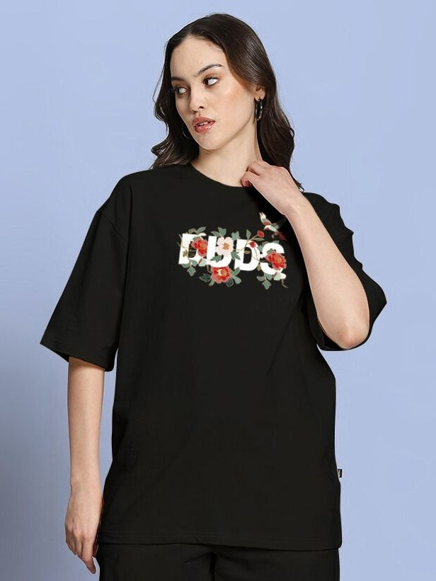 Model wearing WOMEN'S ROSE CHARM OVER-SIZED T-SHIRT BLACK with floral design.
