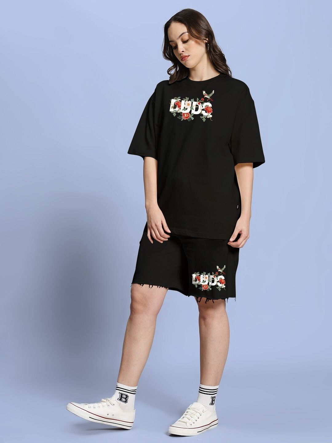 Woman wearing WOMEN ROSE CHARM RELAXED FIT CO-ORD SET BLACK with floral accents, showcasing style and comfort for casual looks.