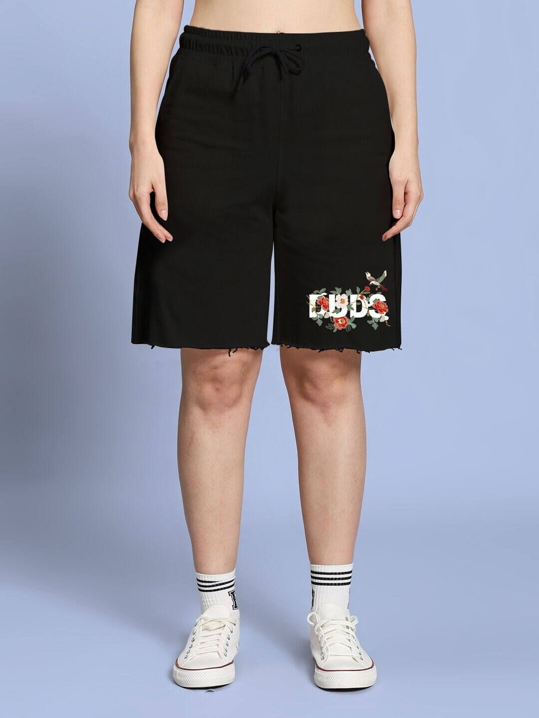 Woman wearing WOMEN ROSE CHARM RELAXED FIT SHORTS BLACK with floral embroidery, showcasing a casual and elegant style.