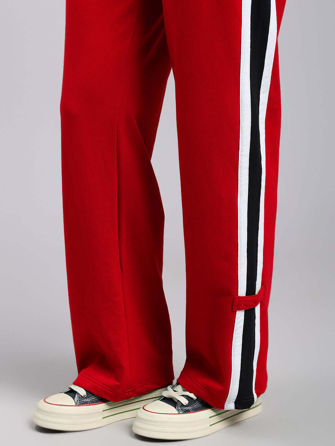 Close-up of WOMENS ROSSTON FLAT-OUT RELAXED FIT JOGGERS RED with stripe detail and casual shoes.
