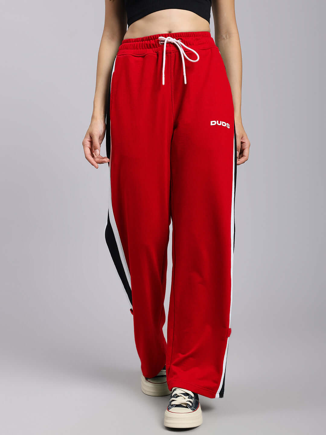 Women's red relaxed fit joggers with white drawstring and black side stripe by DUDS, perfect for comfort and style.