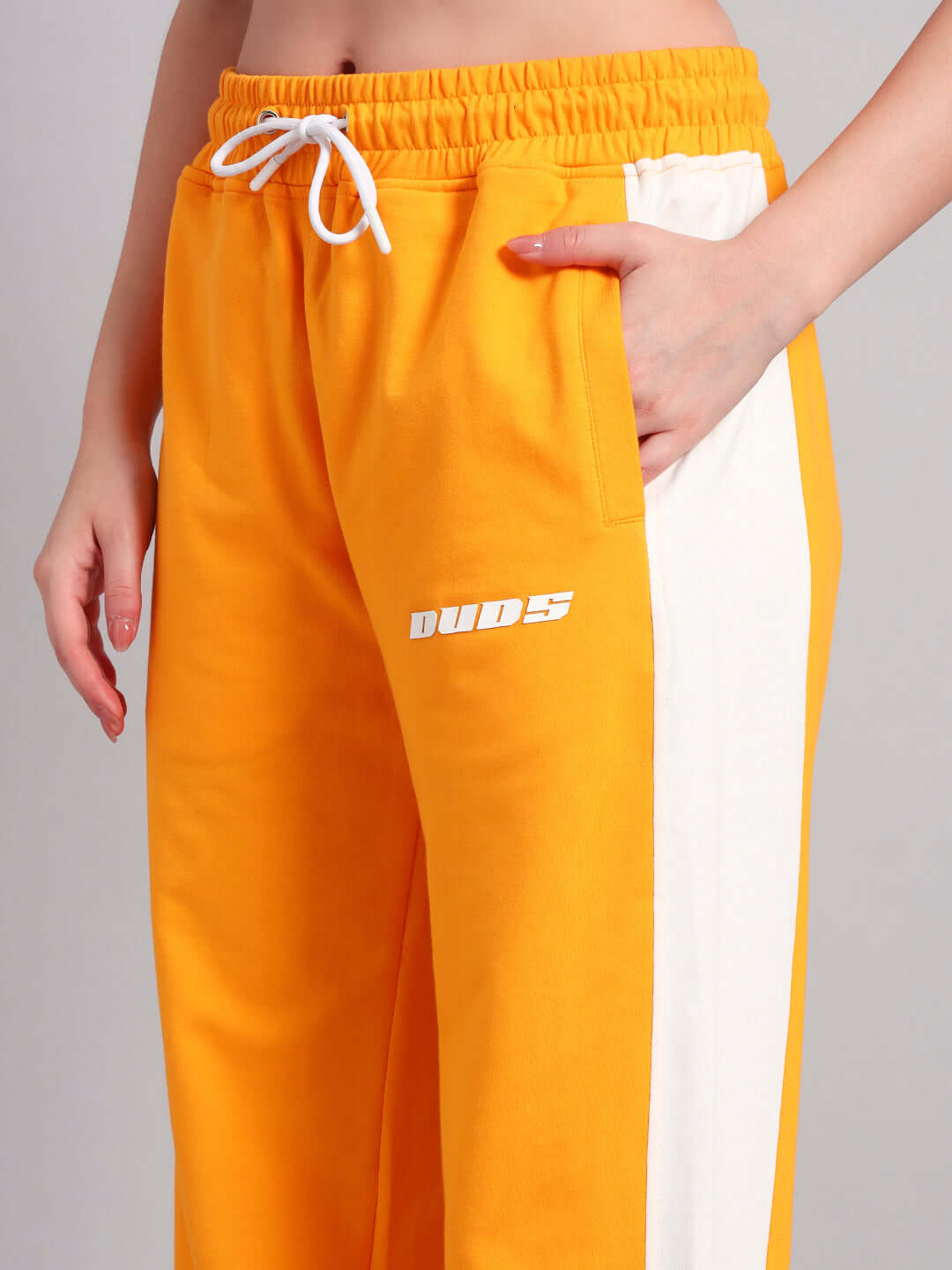 Women's Rox Primer Relaxed Fit Joggers in orange and white, featuring an adjustable drawstring waistband, made by DUDS.