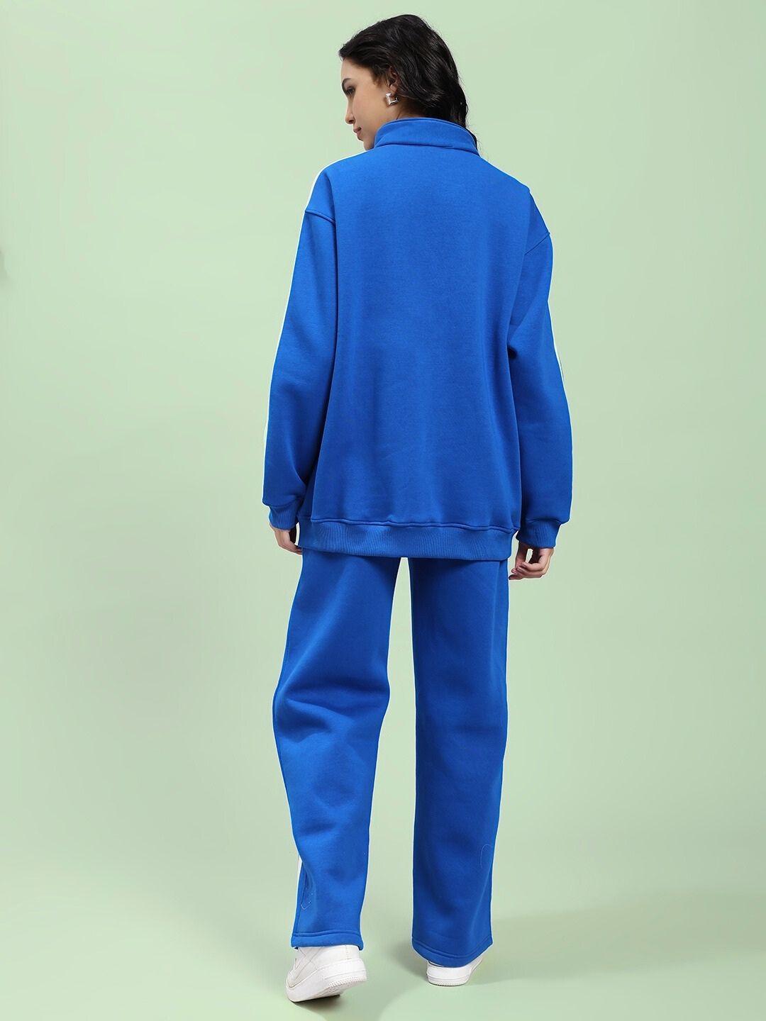 Woman wearing WOMEN RAPID STRIDE ROYAL BLUE COTTON FLEECE CO-ORD SET, showcasing back view in stylish, comfortable attire.