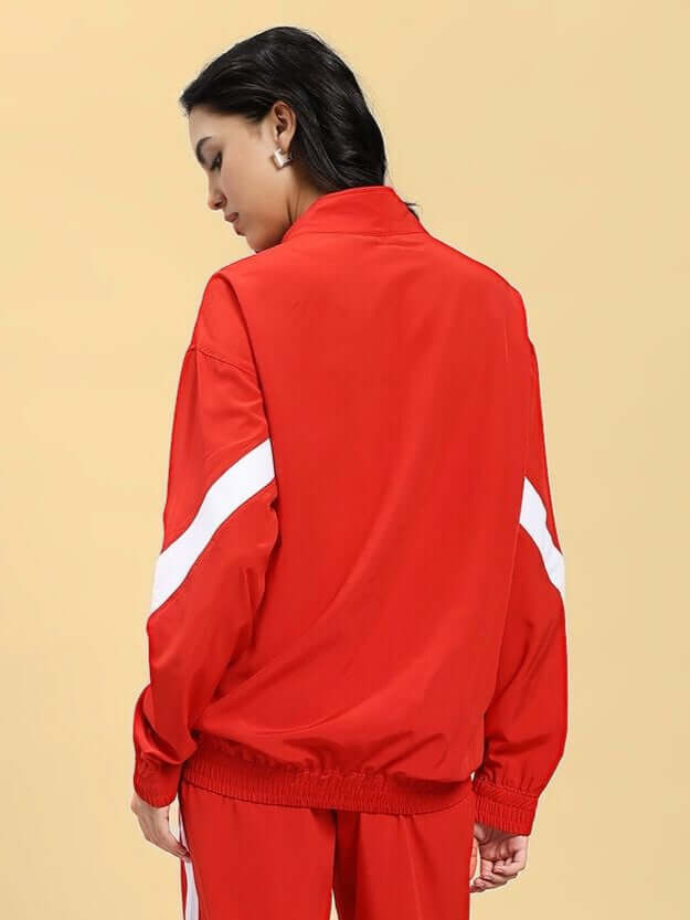 Back view of a woman wearing the WOMEN ROYAL COMFORT RELAXED FIT JACKET RED, highlighting its striking red color and relaxed design.