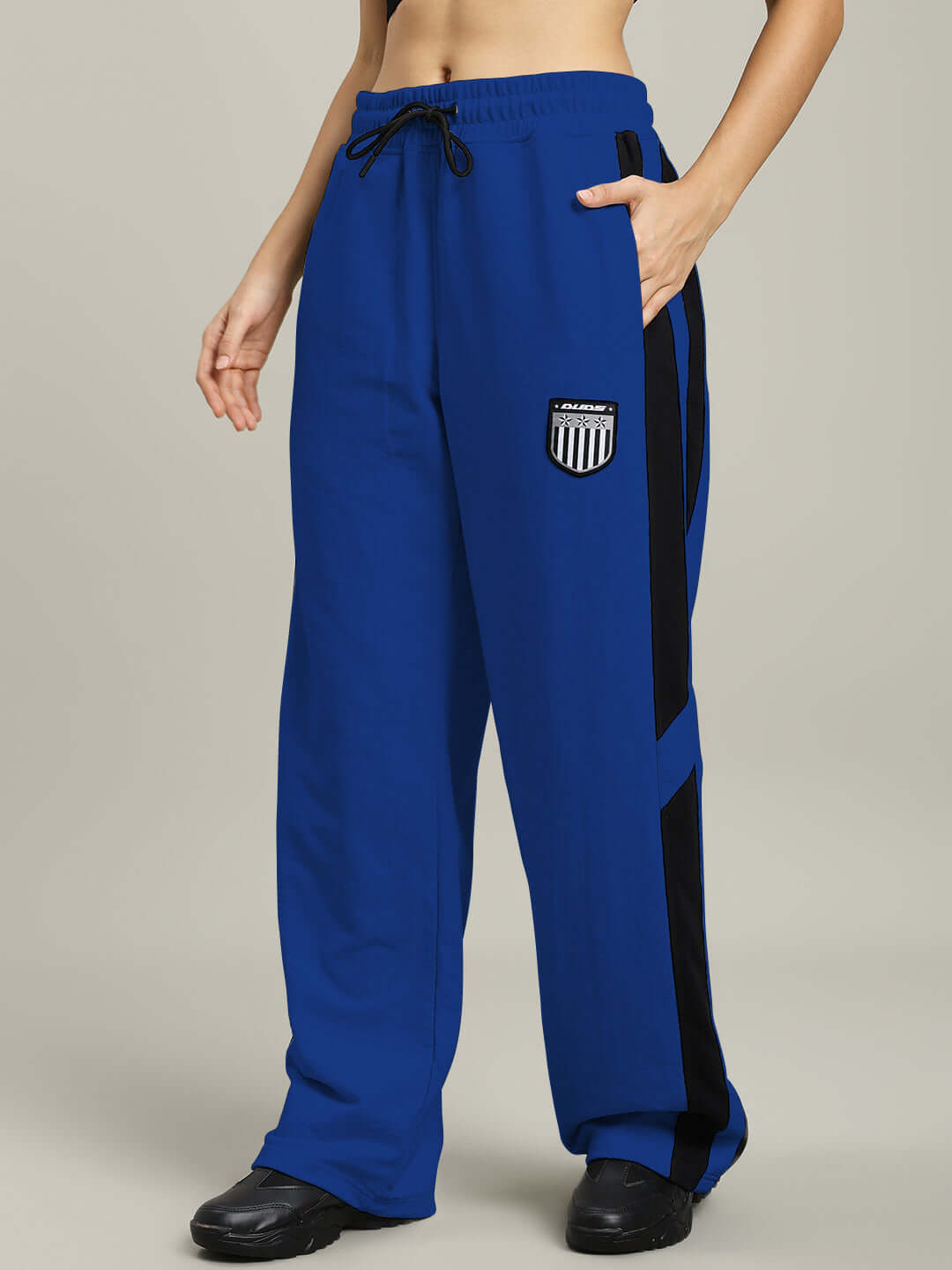 Women's Royalson Joggers in blue with black accents, made by DUDS, shown on a model. Ideal for custom fit and tailored style preference.
