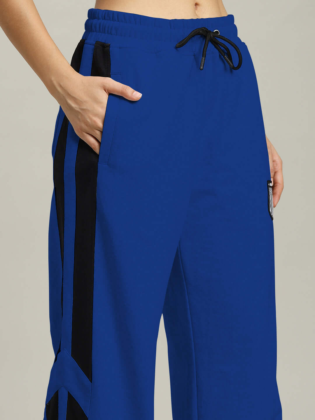 Women's Royalson Joggers in blue with black accents, customizable fit, made by DUDS tailors, showcasing comfortable style.