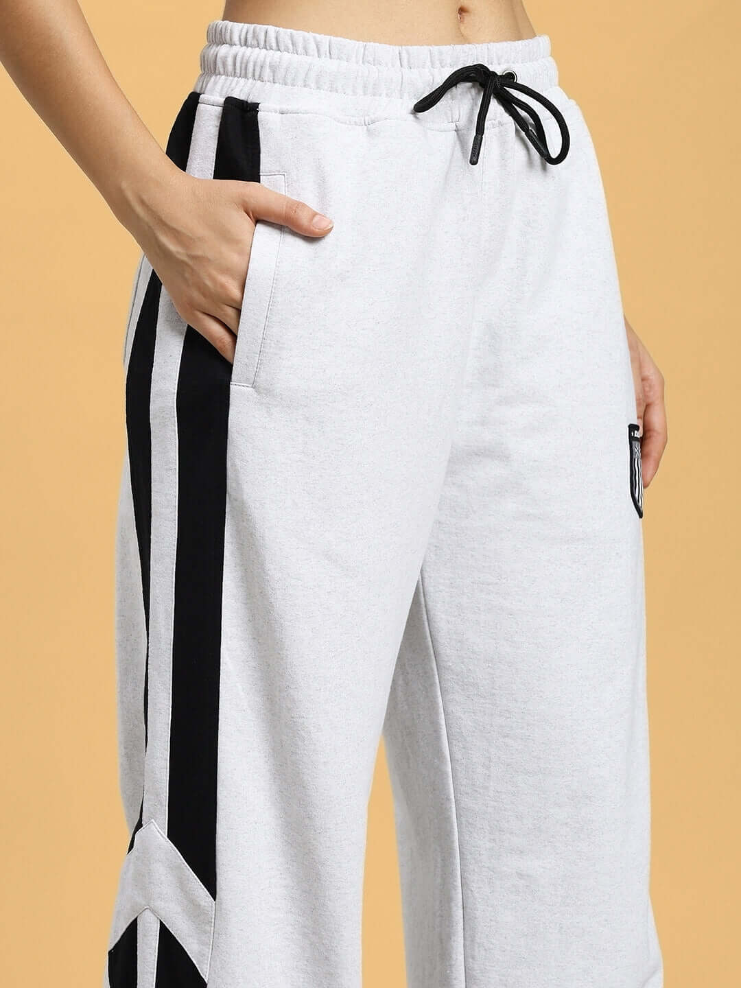 Close-up of WOMEN'S ROYALSON JOGGERS MELANGE-GREY with black accents and drawstring waistband.