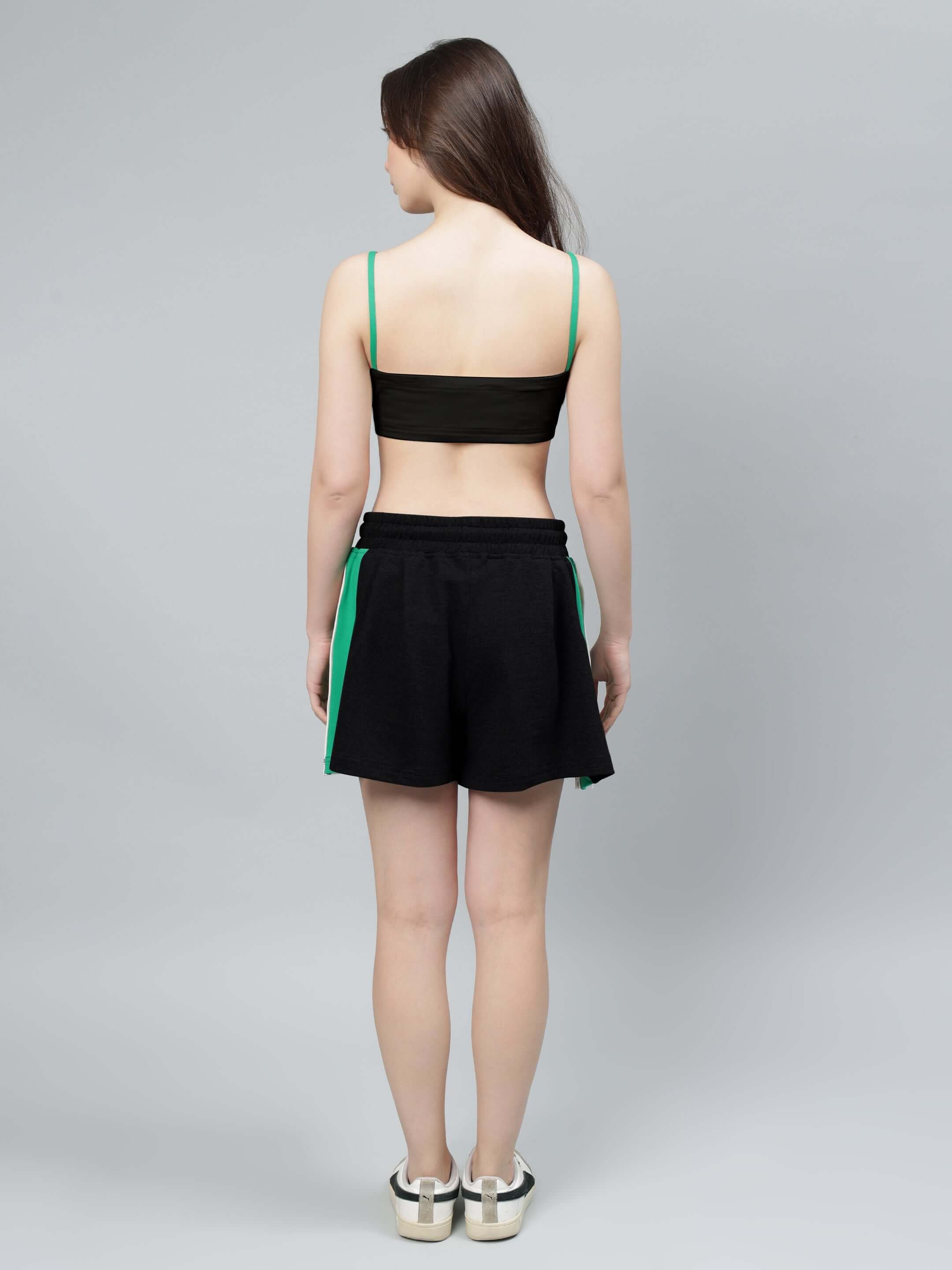 Back view of model wearing WOMEN'S SAMMIE CO-ORD SET BLACK with green accents, showcasing stylish and comfortable fashion.