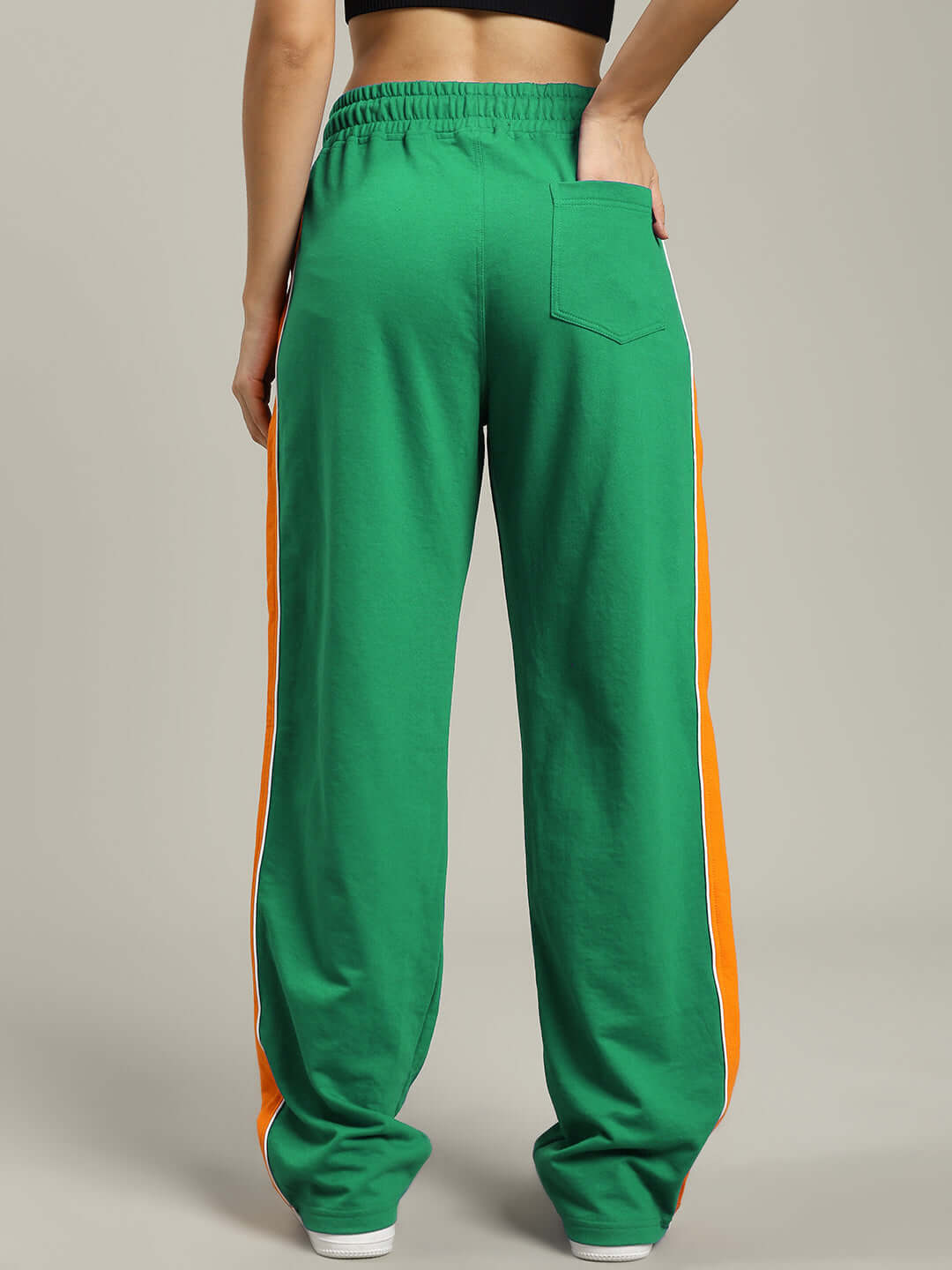 Back view of WOMENS SANFORD STRIPE JOGGERS GREEN with orange side stripes, showing relaxed fit and pocket detail, perfect for casual wear.