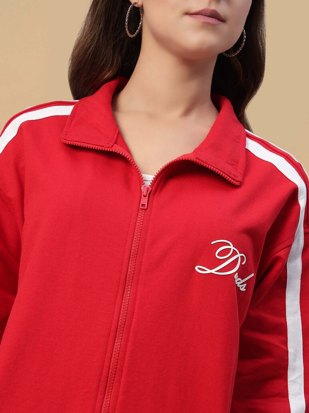 Close-up of a woman wearing a red Women's Scotia Co-Ord Set made of premium heavy gauge cotton terry fabric with a zip-up collar.