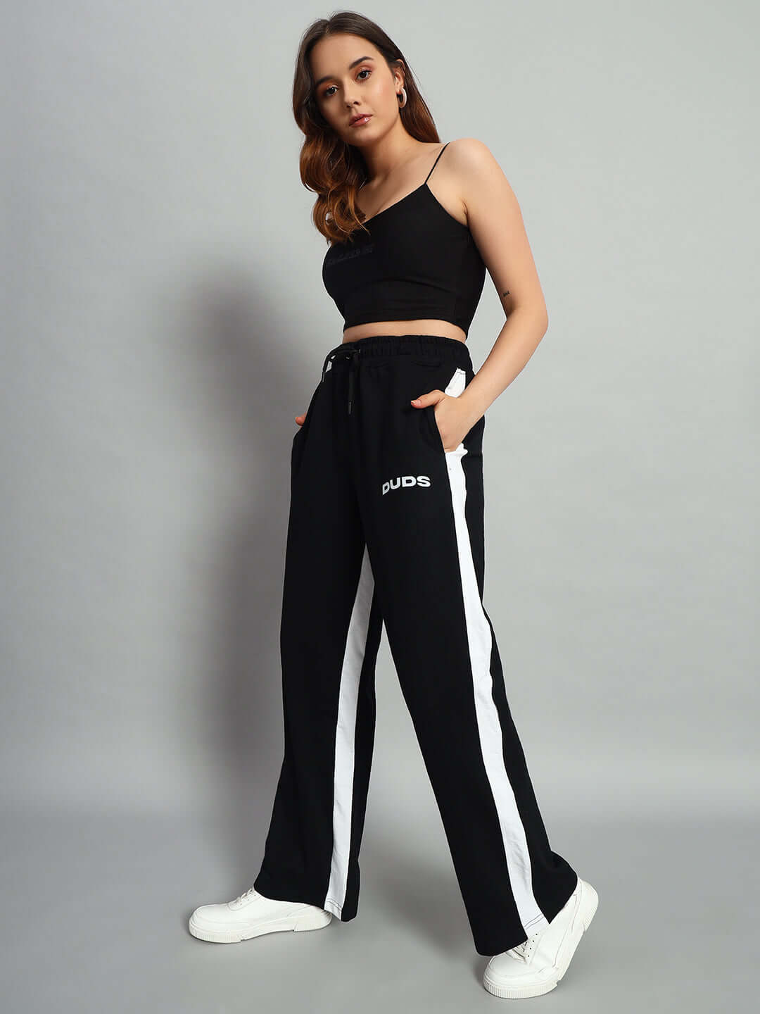 Woman wearing black side seam baggy joggers by DUDS, customizable fit available.