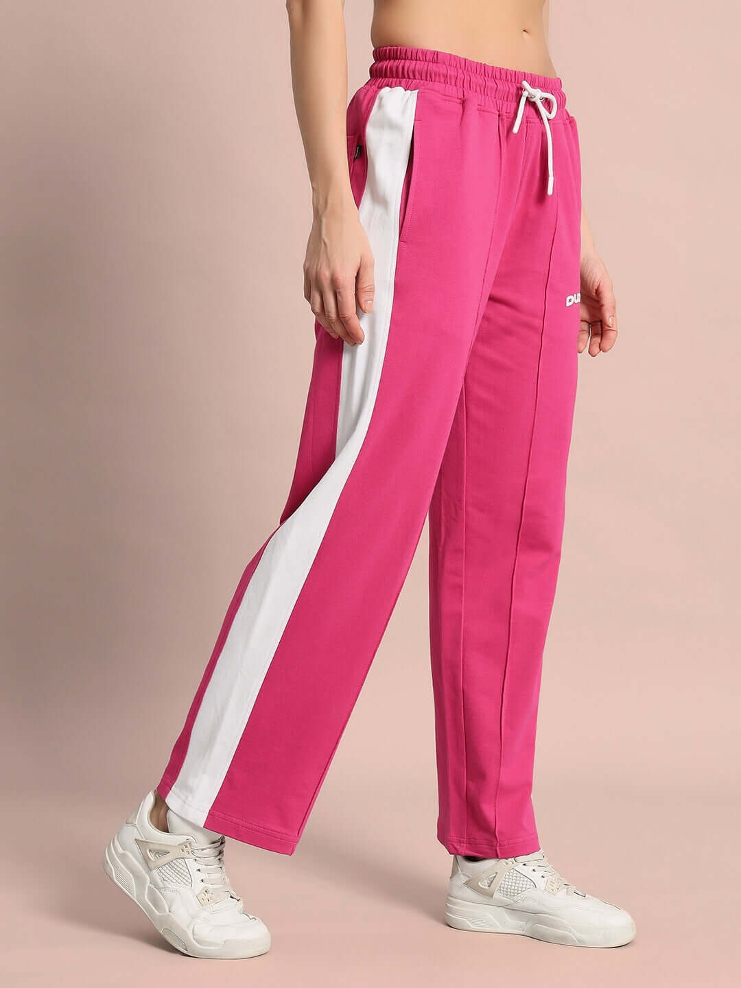 Pink women's joggers with white side seams, designed for comfort and style by DUDS, customizable sizing available.