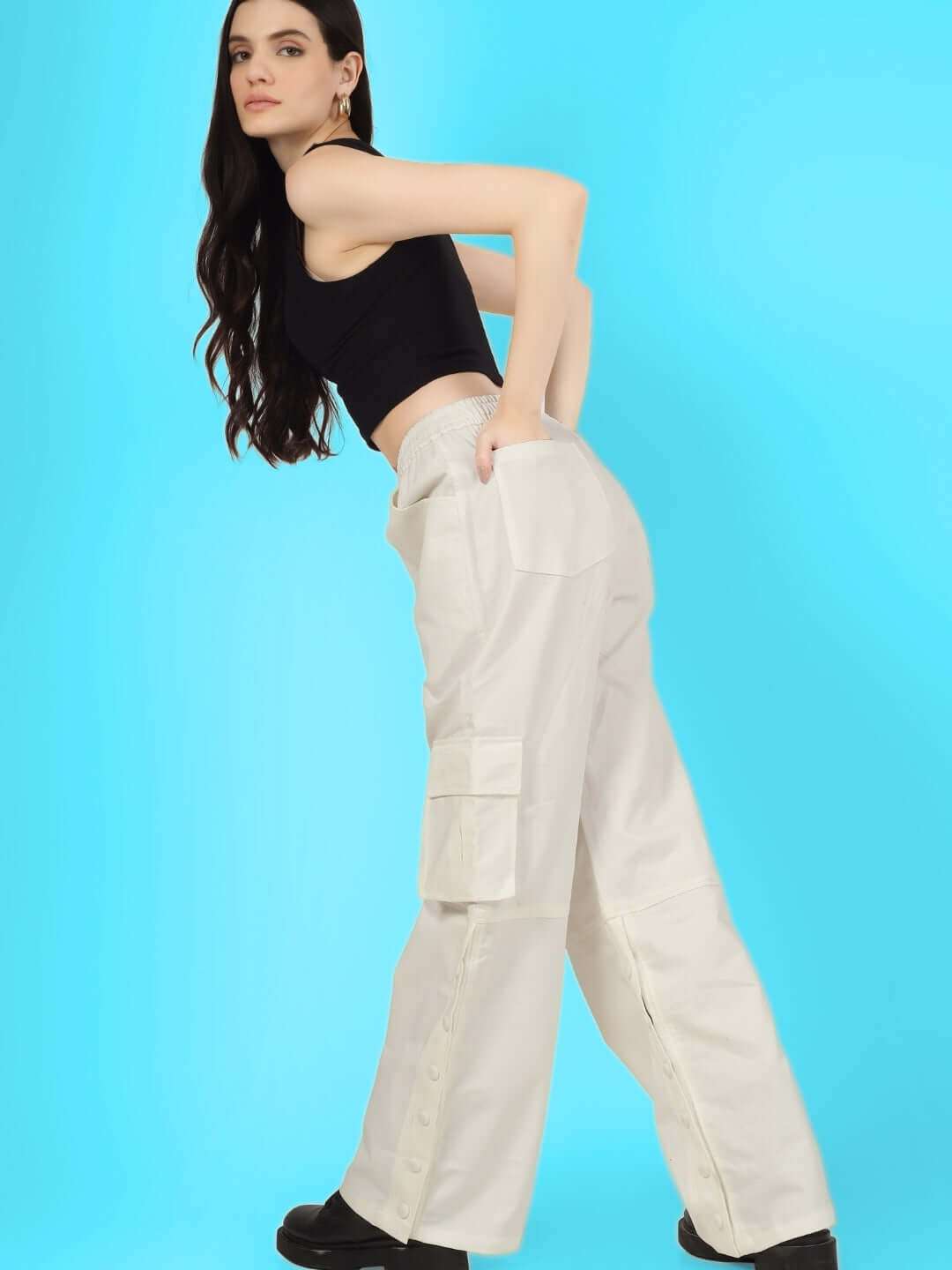 Model wearing women's white side slit button cargo pants by DUDS, showcasing fashion-forward design with a customizable fit option.