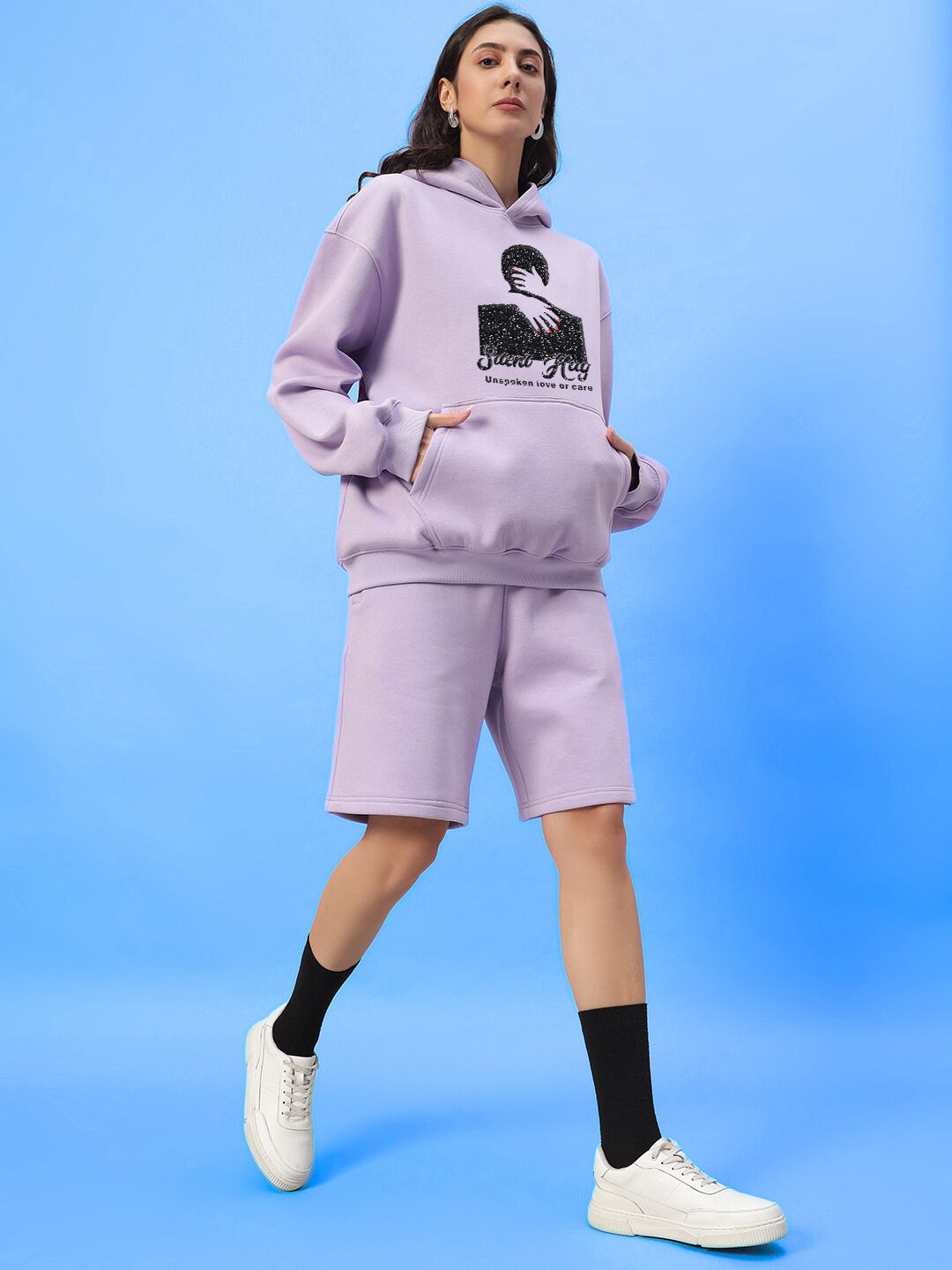 Woman wearing WOMENS SILENT HUG PRINTED FLEECE CO-ORD LILAC, featuring cozy fleece fabric and artistic print in pastel lilac.