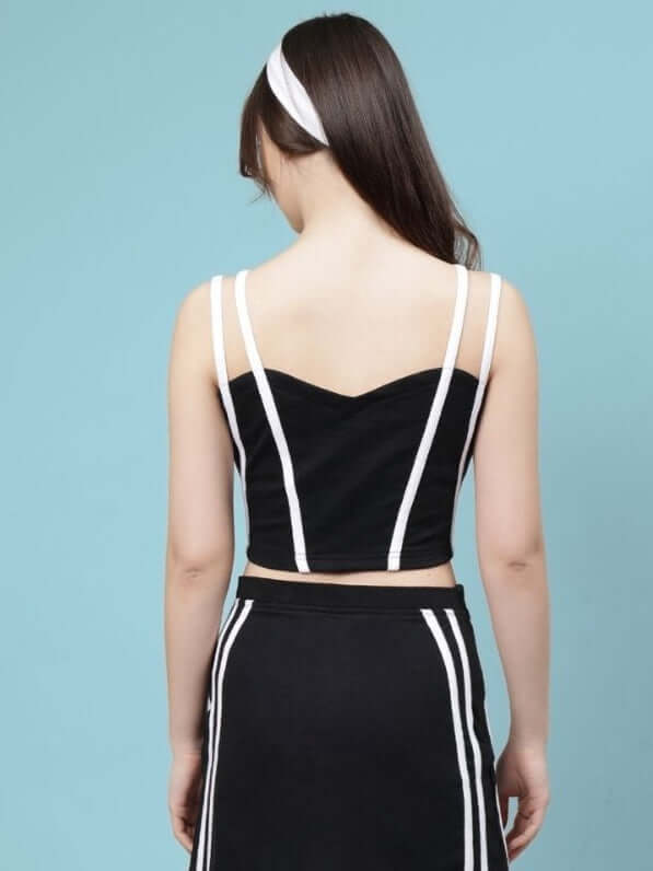 Back view of WOMEN'S SIMONE CROP-TOP - BLACK showcasing stylish design with white accents.