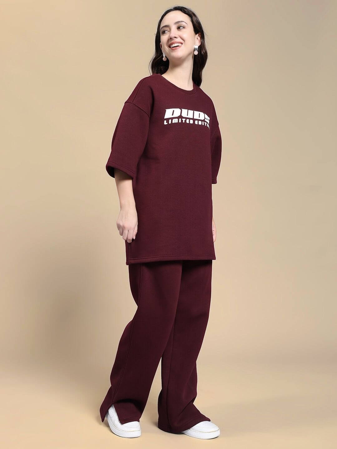 Woman wearing WOMEN SKODA FLEECE CO-ORD SET MAROON with graphic tee and wide-leg trousers in a stylish and comfortable pose.