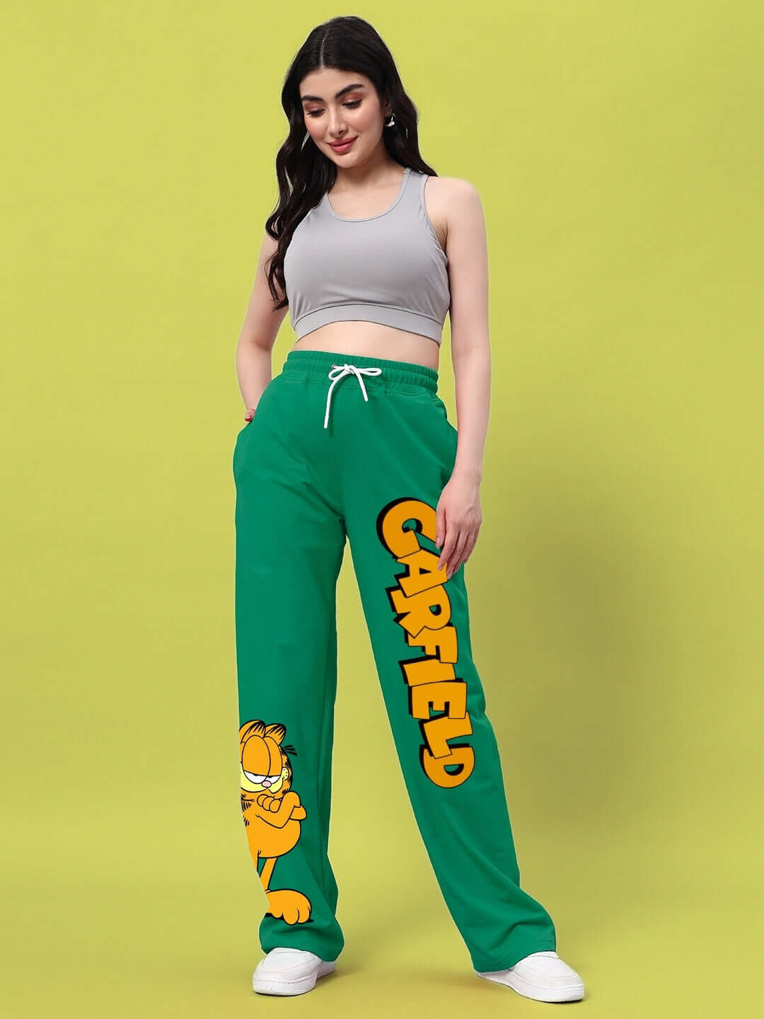 Woman wearing WOMEN'S SMUG GARFIELD RELAXED FIT JOGGER GREEN showcasing playful cartoon design.