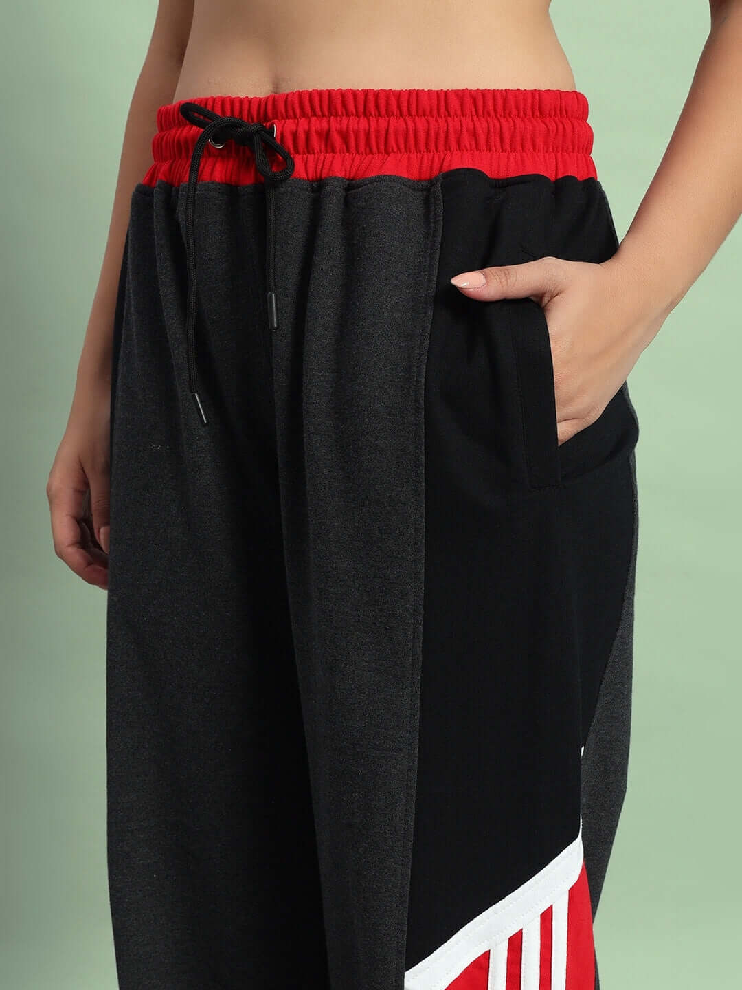 Women's relaxed-fit joggers in dark grey and red with pocket detail, tailored by DUDS for a custom fit experience.