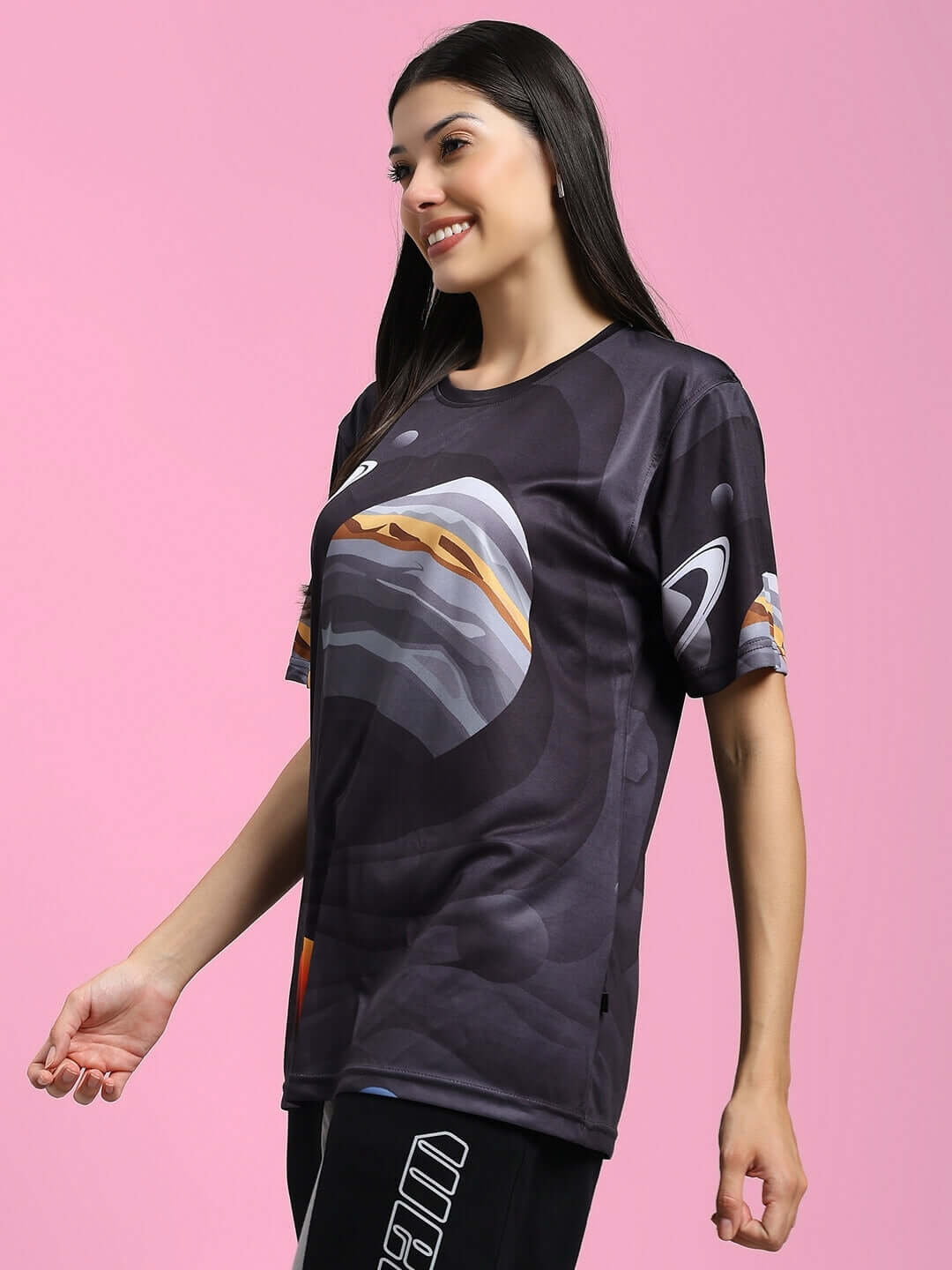 Woman wearing a women's black space fantasy printed t-shirt made of sports polyester with a galactic design, perfect for casual wear.