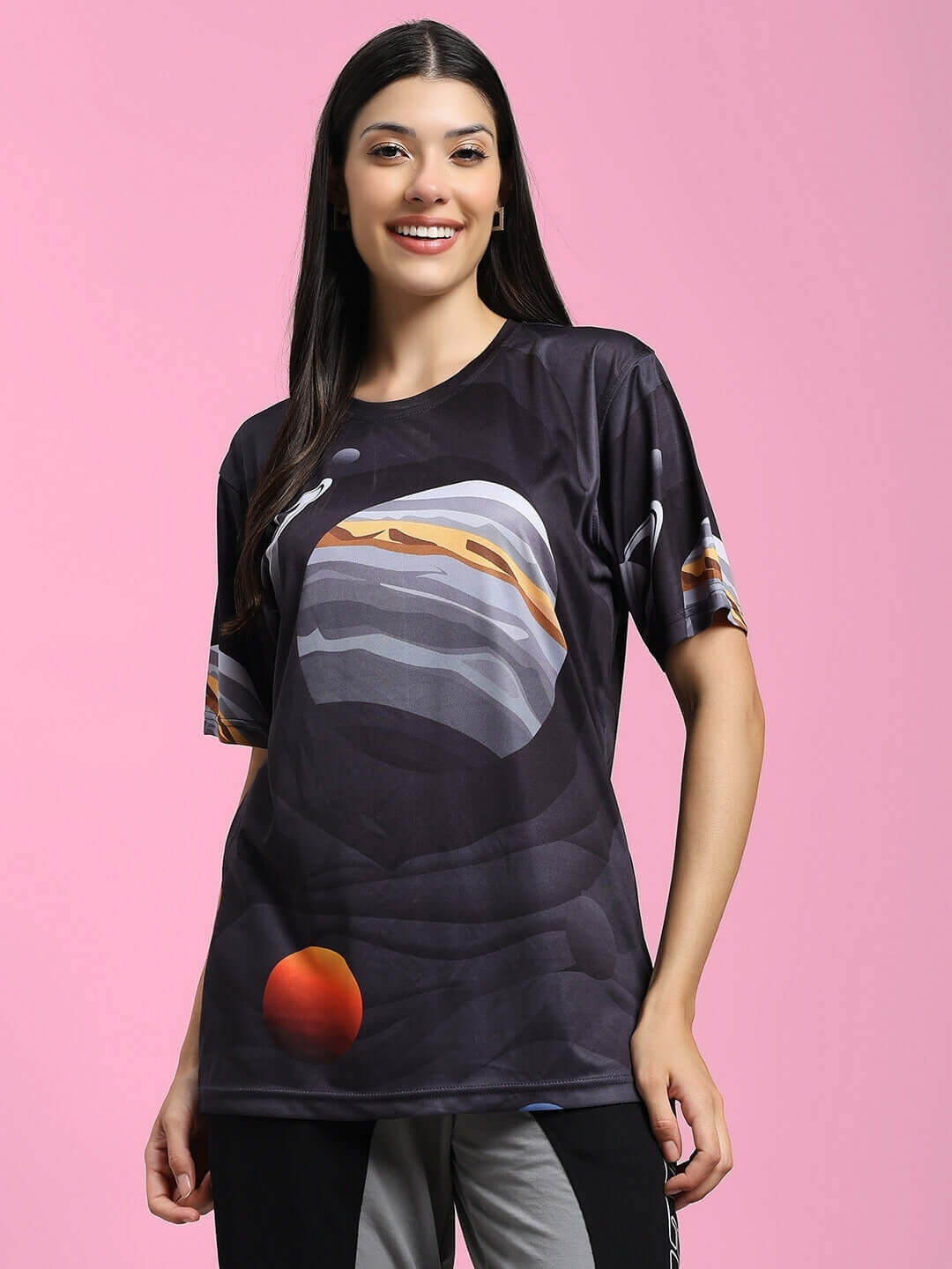 Women's space fantasy printed t-shirt in black, featuring sports polyester fabric, modeled against a pink background.