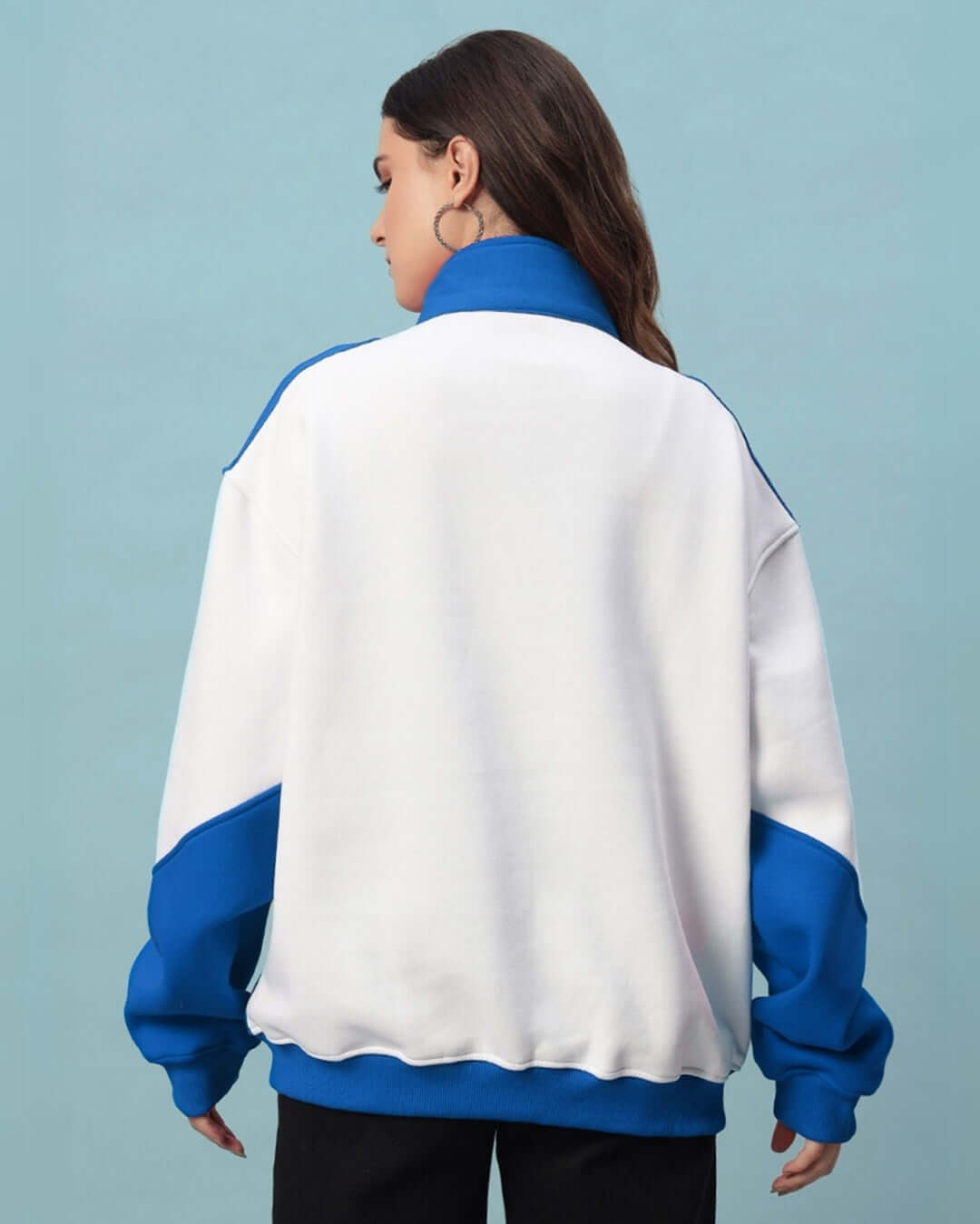 Back view of a woman wearing a women's royal blue colorblock jacket, featuring a relaxed fit and crafted from premium fleece.