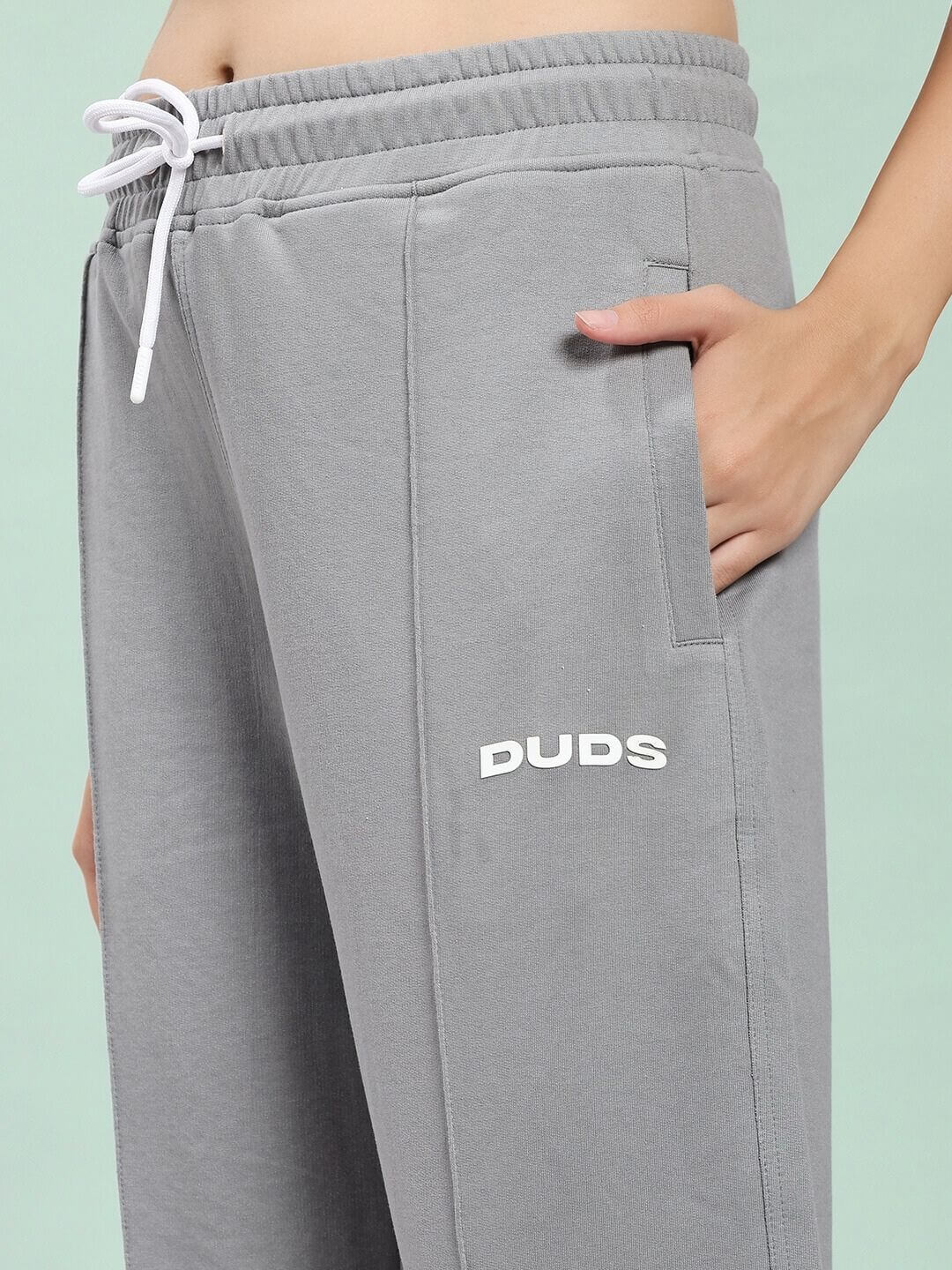 Close-up of WOMEN SPIRAL RELAXED-FIT JOGGERS GREY with hand in pocket, showcasing the soft cotton-blend fabric and relaxed fit.