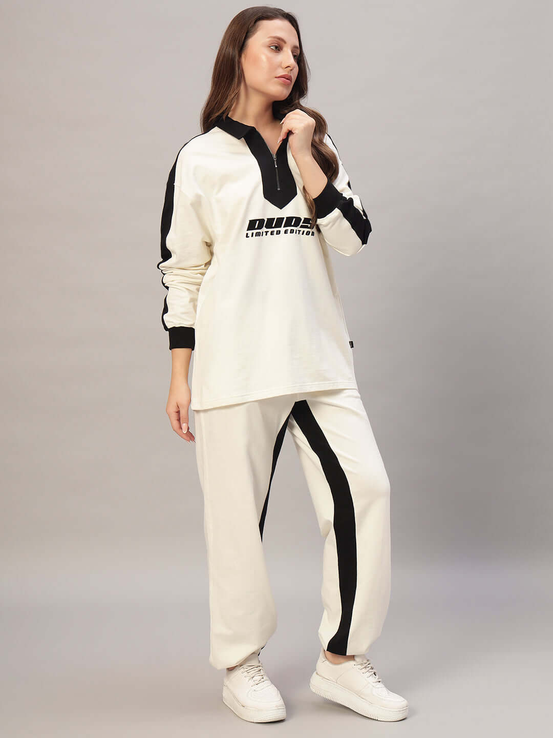 Woman wearing WOMEN SPLINTER OVERSIZED CO-ORD SET OFF WHITE BLACK with oversized sweatshirt and joggers.