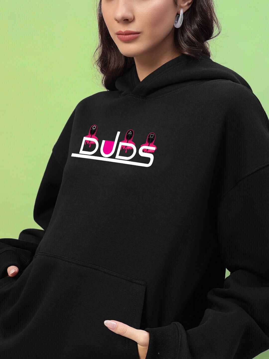 Woman wearing WOMENS SQUID GAME OVERSIZED HOODIE BLACK with minimal graphic design.