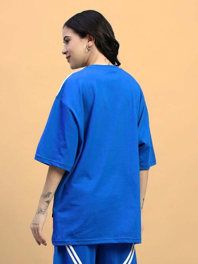 Back view of women's blue oversized star jumper T-shirt, featuring premium cotton fabric and relaxed fit, styled casually.