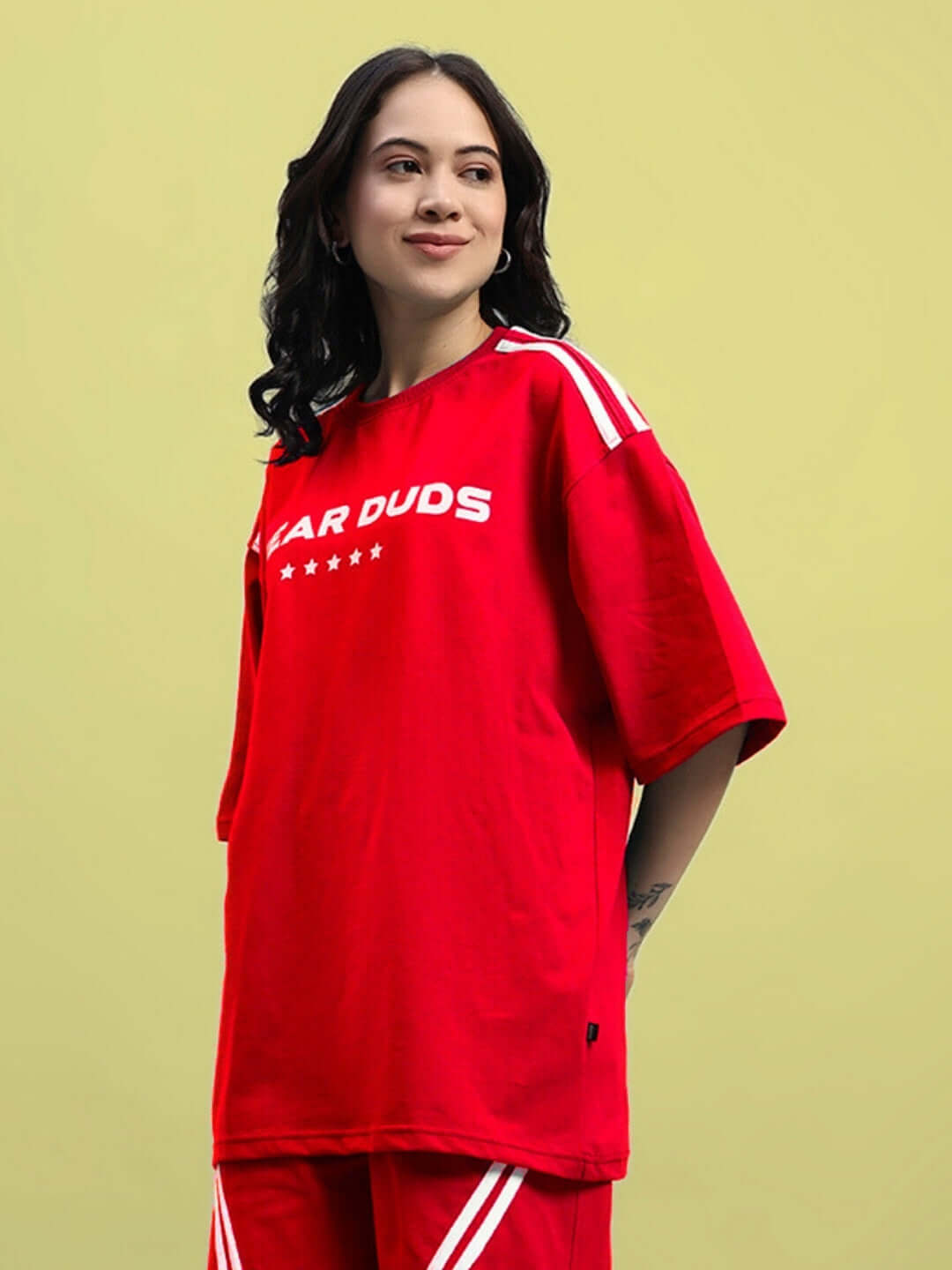 Model wearing a red Women's Star Jumper over-sized T-shirt made of premium cotton, featuring comfortable fit and stylish design.